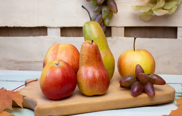 Fresh fruits. Healthy food. Mixed fruits, pears, apples and grapes. Studio photography of various fruits on an old wooden table. Organic healthy assortment of fruits. Assortment of fresh fruits.