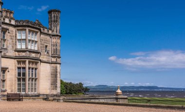 Edinburgh, İskoçya, İngiltere - 14 Haziran 2012: Köşe Dalmany evi, konak ve kalede Tudor revival stil ve Firth of Forth arkada. Mavi gökyüzü.