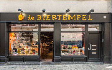 Brussels, Belçika - 26 Eylül 2018: De Biertempel en ünlü Belçika bira ve mal dükkanı şehir merkezinde. Siyah çerçeve sarı işareti. Renkli ekran windows.