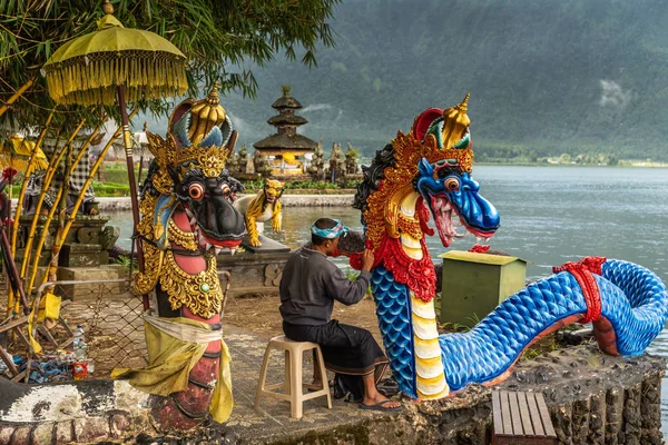 Людина малює воду драконів у Temple комплексі Ulun Danu Бератан, Be — стокове фото