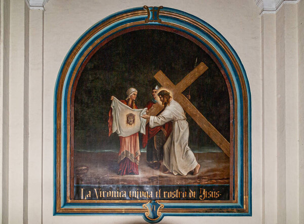 Leon, Nicaragua - November 27, 2008: Cathedral of Assumption, Asuncion.. Closeup of sixth station of the cross painting against white wall, shows Veronica wiping Jesus face.