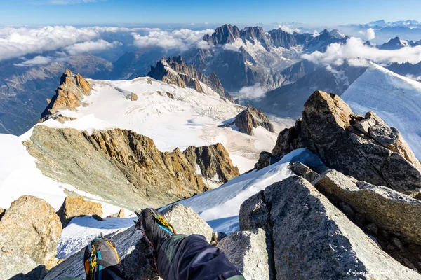 Alpinist mountaineer feet mountain summit landscape Mont Blanc.