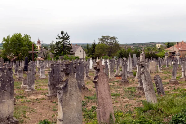 Zsambek, Hungary - 05 10 2020: Old cemetery in Zsambek, Hungary on a cloudy spring day.