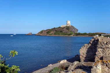 Arka planda İspanyol kulesi olan Nora 'nın arkeolojik alanı..