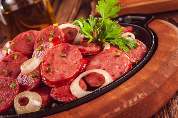 Dilimlenmiş közlenmiş sosisli ve soğanlı Brezilya mezesi.