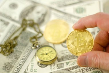 Cep saati ile dolar banknotları üzerinde Bitcoin'i El Tut