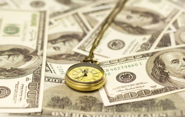 Dollar bills and pocket watch