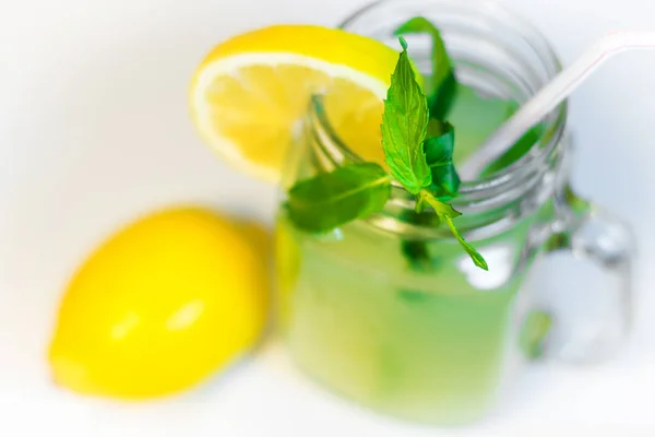 mason jar glass of lemonade isolated white