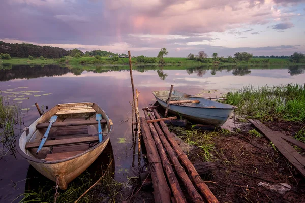 Picture of a row boat on Russian river Nerl on sunset. Blue sky and amazing clouds — Stock Image Picture of a row boat on Russian river Nerl on sunset. Blue sky and amazing clouds Stock Photo