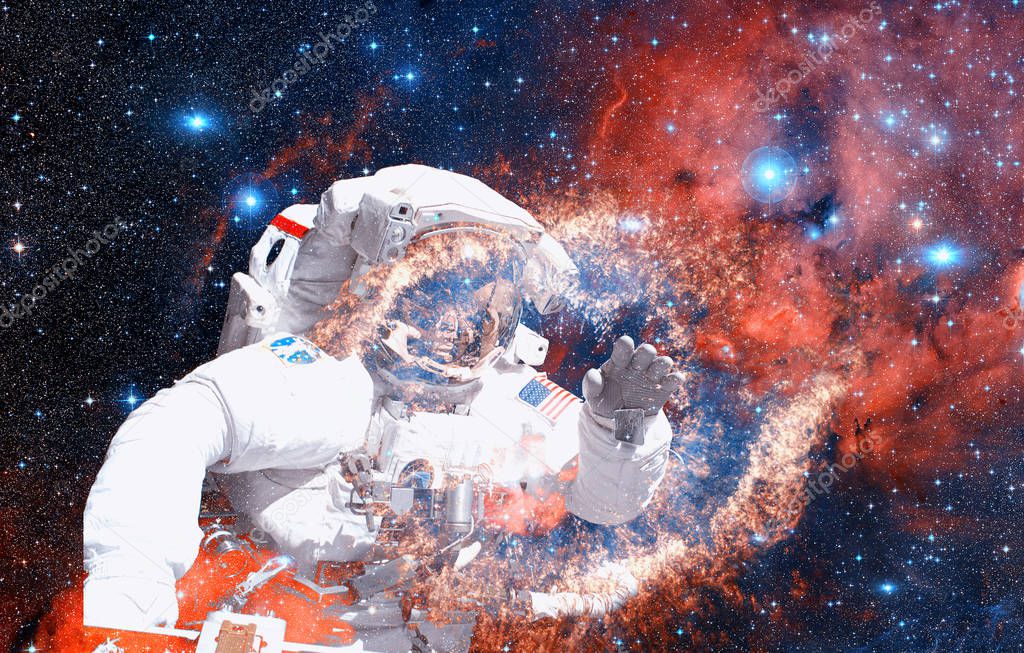 Astronaut in deep space against the background of the nebula. Elements of this image furnished by NASA.