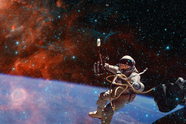 Astronaut. Nebula, cluster of stars in deep space. Science fiction art. Elements of this image furnished by NASA