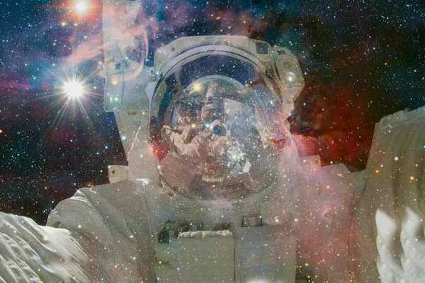 Astronaut. Nebula, cluster of stars in deep space. Science fiction art. Elements of this image furnished by NASA