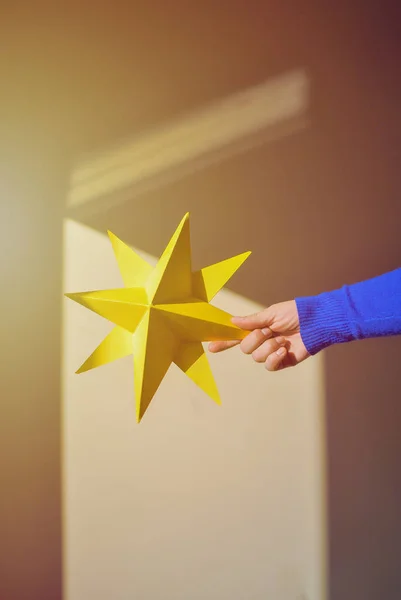 Yellow star in a woman\'s hand. Make a wish come true
