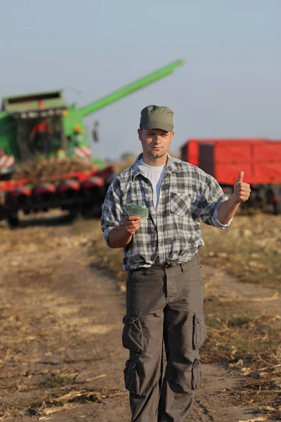 Agricultor Sosteniendo Billete Euros Gesticulando Con Cosechadora Combinada Fondo Pulgar — Foto de Stock