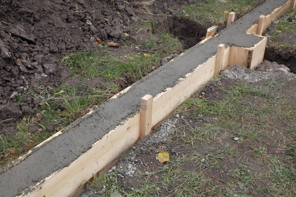 Concrete in wooden formwork for wall foundation