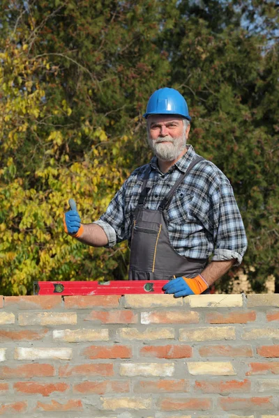 Smiling Worker Control Brick Wall Using Level Tool Thumb Royalty Free Stock Photos