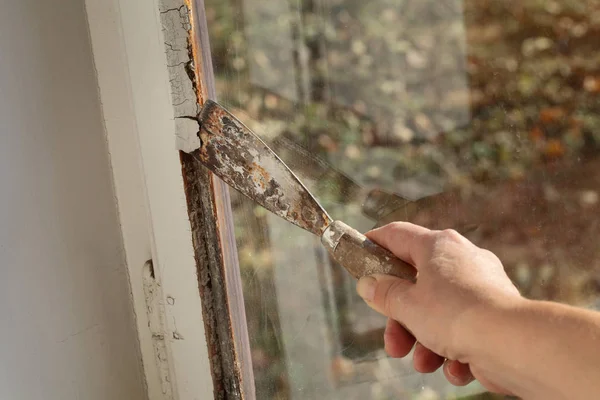 工人去除油窗玻璃腻子使用腻子刀工具 旧窗口修复 — 图库照片