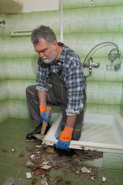 労働者を削除 古い浴槽とタイルを浴室でハンマーで解体 — ストック写真