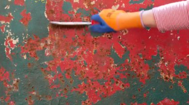 Tel fırça kullanarak eski metal plakadan pas çıkarma, aletle closeup oh el