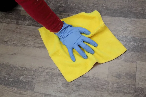 Hand in glove cleaning laminate floor — Stock Photo, Image