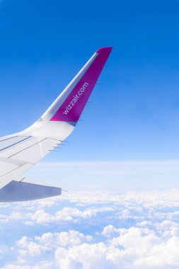 Wizzair airline wing. Sky view from the airplane window.