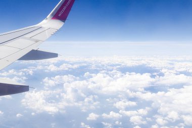 Wizzair airline wing. Sky view from the airplane window.
