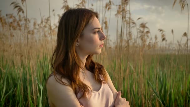 Portrait of young ginger girl in a forest, looking at camera, smiling, thinking, nature background, concept 50 fps — Stock Video