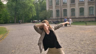 Mutlu kız kameraya, hareket kavramı izlerken gündüz, yaz aylarında dans ediyor