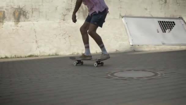 Skateboarder haciendo truco de skate en la vieja pared y patinaje en la ciudad moderna — Vídeos de Stock