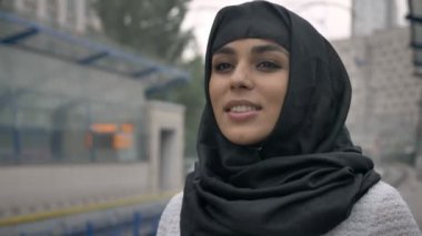 Hijab rüya Müslüman kadında genç tren, yağmur, din kavramı, kentsel kavramı için bekliyor. Hava kavramı