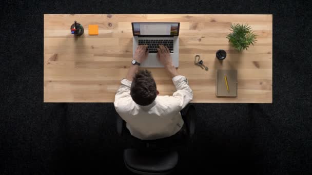 Young man is tapping on laptop, turns off computer, work concept, office concept, communication concept, top shot — Stock Video