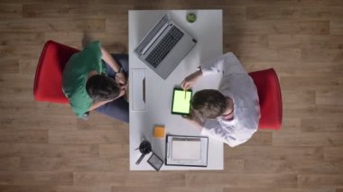 Danışma için hasta gösteren tablet sağlayan chromakey, topshot, tıbbi kavramı ile gözlüklü genç doktor