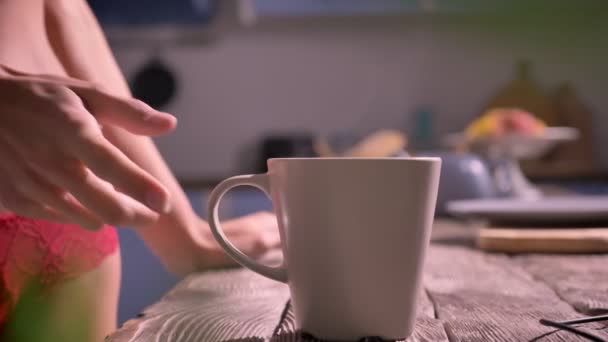 Close shot of young sexy womans hand taking cup, woman coming and going away from kitchen, attractive and seductive — Stock Video