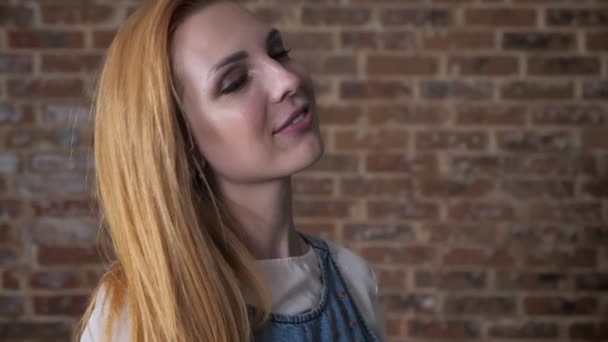 Young happy blonde girl is dancing, relax concept, brick background — Stock Video