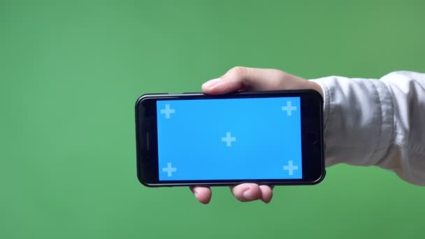 Close footage of mans hand pointing phone with chromakey in camera, chromakey background — Stock Video