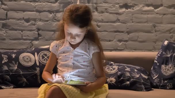 Liten Flicka Sitter Soffan Och Skriva Tablett Kid Spelar Gadget — Stockvideo
