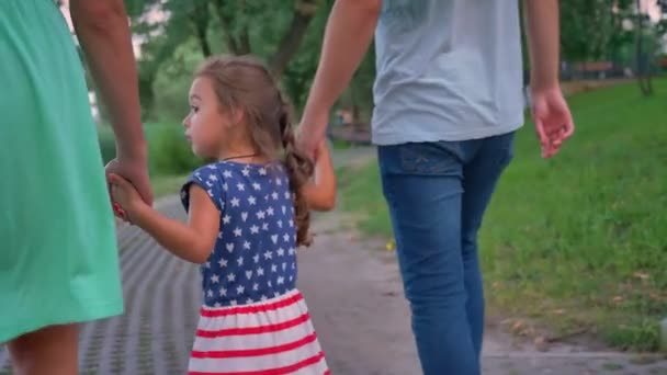 夏季は、日没公園のパスを歩く若い家族のシルエット — ストック動画