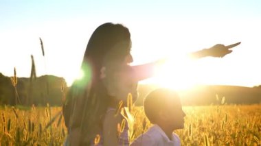 Çocuk Asya Anne yaz aylarında alanında oturup, bir şey üzerinde aile kavramı, yan görünüm üzerine gelin