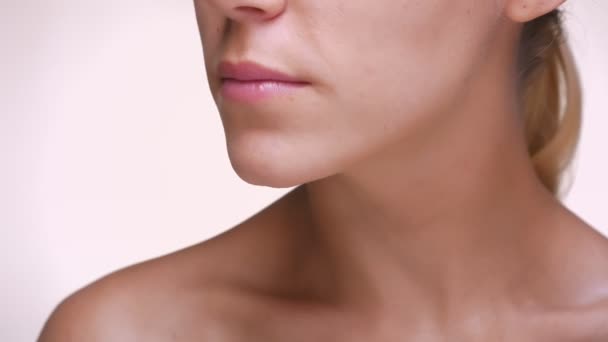 Close-up Kinn und Schlüsselbein eines kaukasischen Mädchens mit klarer, perfekter Haut im weißen Studio nackt — Stockvideo