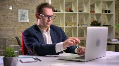 Şirin şık beyaz erkek eserleri üzerinde duruldu ve içme suyu Office tarafından dinlenme laptop, yazma