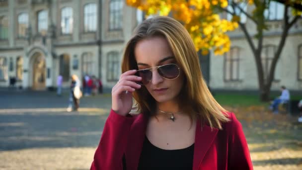 Jovem mulher na moda, estudante irritado e frustrado olha para os óculos e rola os olhos, fora da universidade em um dia ensolarado — Vídeo de Stock