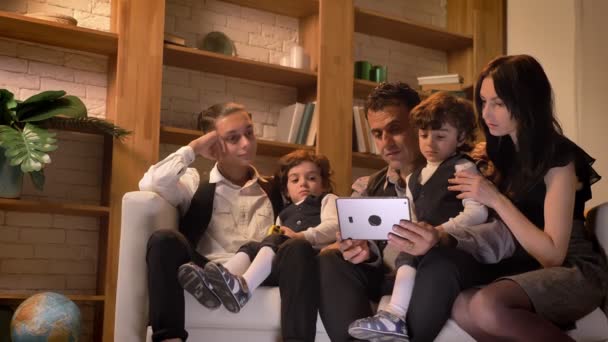 Ritratto di famiglia araba seduta sul divano e che guarda in modo interessante in tablet in soggiorno in un'atmosfera accogliente . — Video Stock