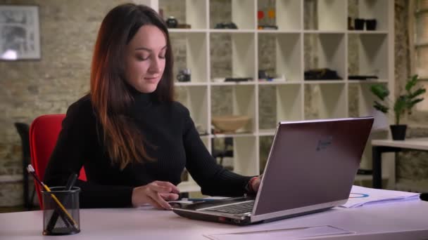 Jonge Kaukasische brunette zakenvrouw melding op smartphone ontvangt en krijgt zeer tevreden werken met office. — Stockvideo