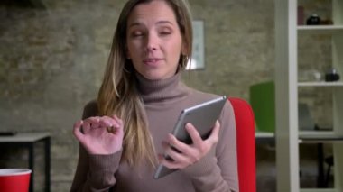 Tablete yazma ve ekran kamera gülümseyen için gösterilen çekici beyaz portre portre