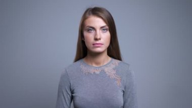 Kamera arka plan ile düz görünümlü genç çekici beyaz kadın portresi closeup gri izole