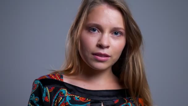 Primer plano retrato de encantadora joven mujer caucásica mirando a la cámara posando y sacudiendo su cabello — Vídeos de Stock