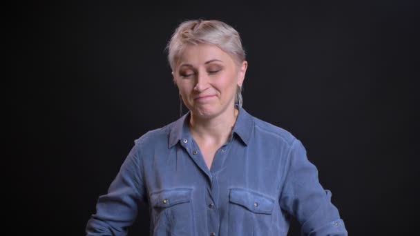 Closeup portrait of adult caucasian woman smiling and nodding in token of approval looking at camera — Stock Video