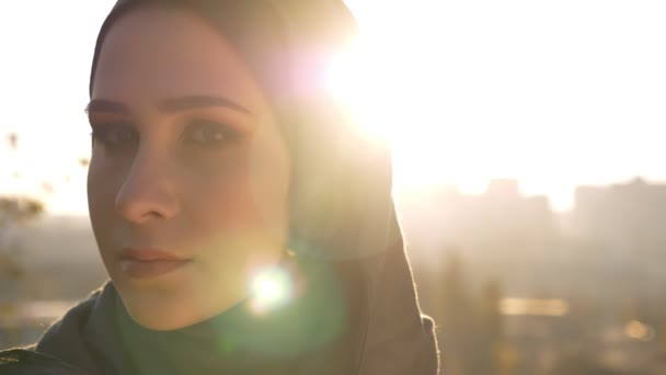 Closeup portrait of young attractive woman in hijab turning head from the left and looking at camera confidently — Stock Video