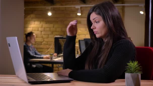 Closeup portrait of distressed adult caucasian businesswoman getting frustrated and confused while working on the laptop — Stock Video