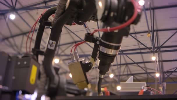 Shot of working black laser automatic robotic mechanism in process on exhibition background. — Stock Video